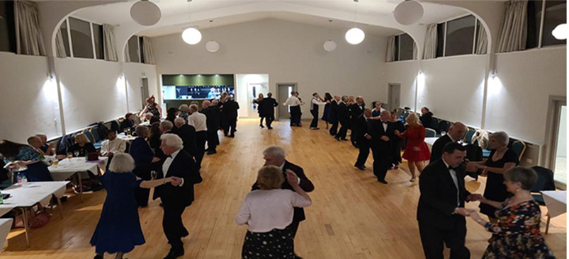 Beginners celebrating progress at a social dance event