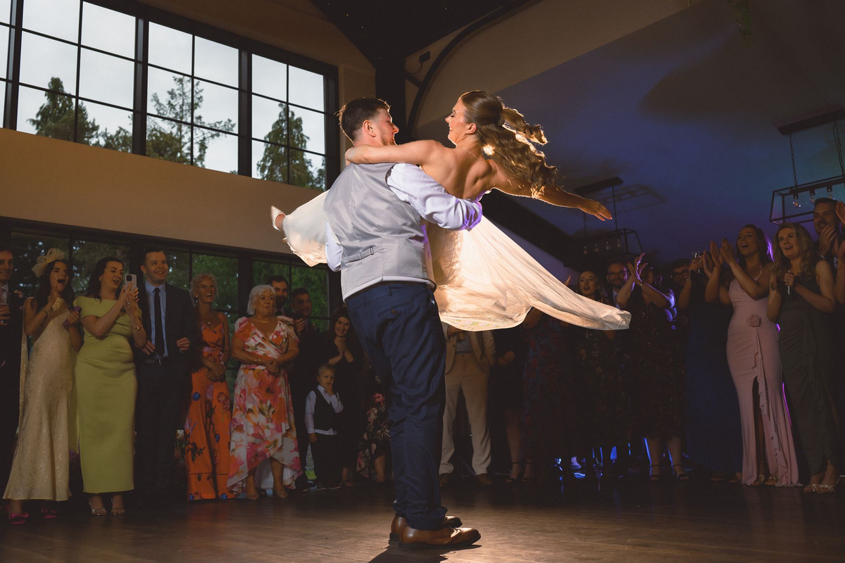 A beautiful lift moment as the groom spins the bride during their dance