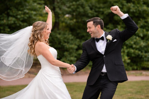 wedding couple with hands in the air